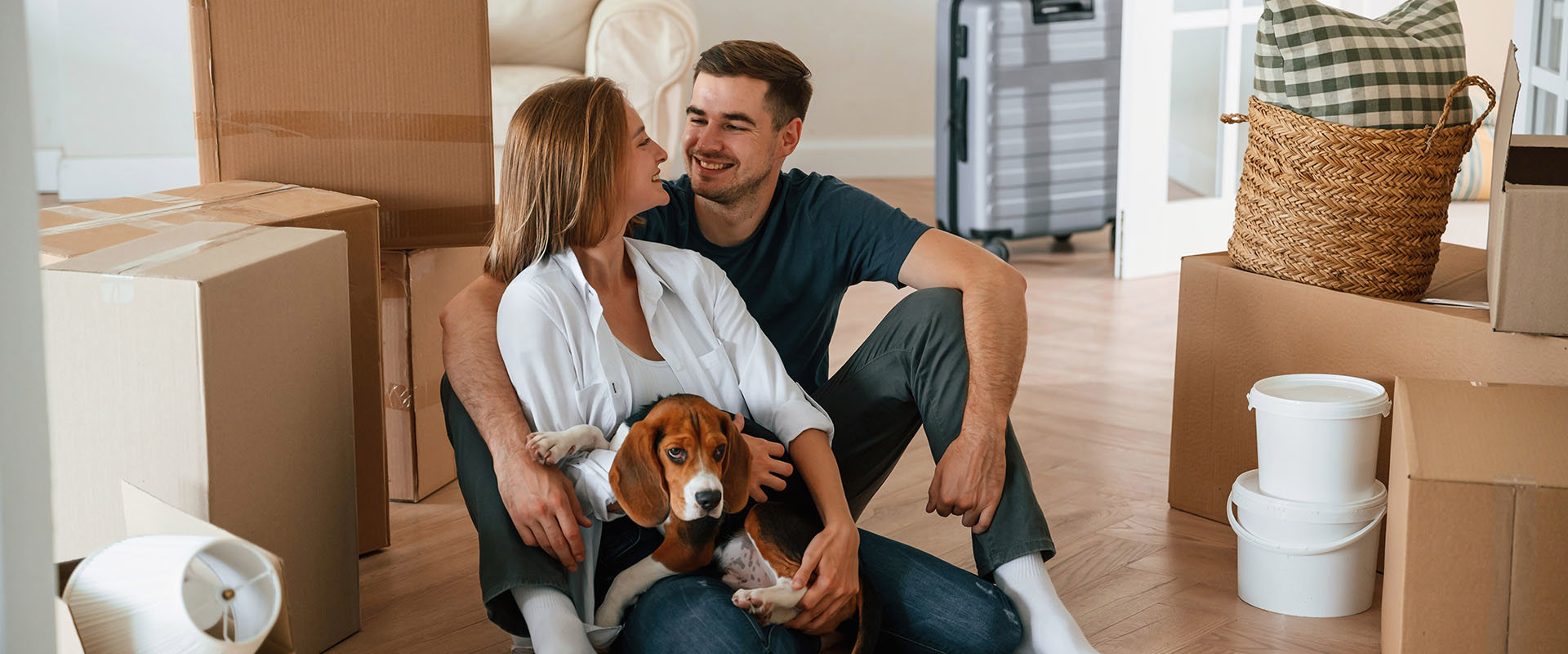 Young Couple With Dog Moving Into New Home